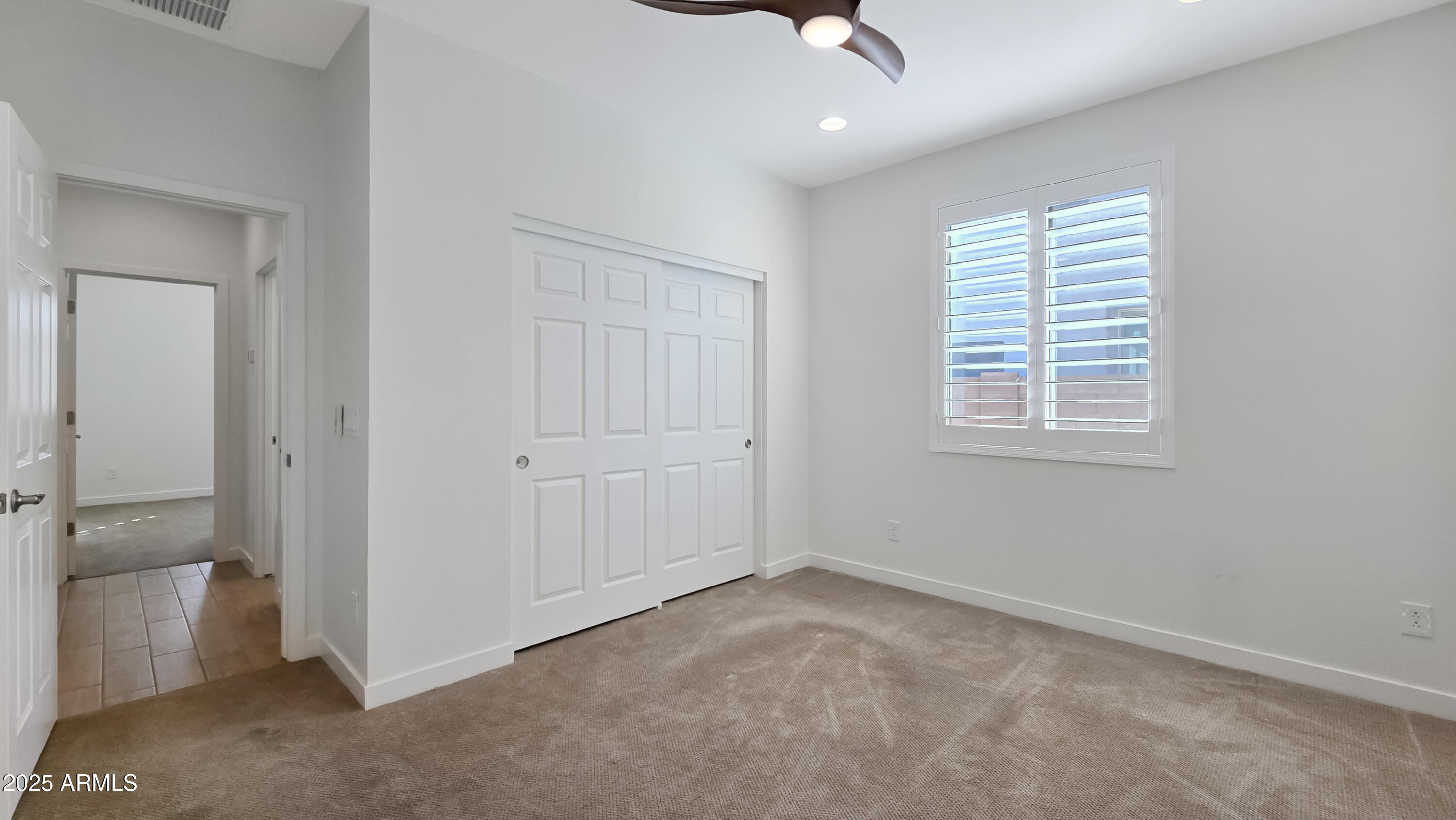17864 West Thistle Landing Drive Goodyear, AZ 85338 - Photo 4 of 43 a view of an empty room with a window