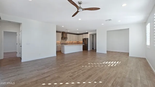 a view of a kitchen with a sink and a refrigerator
