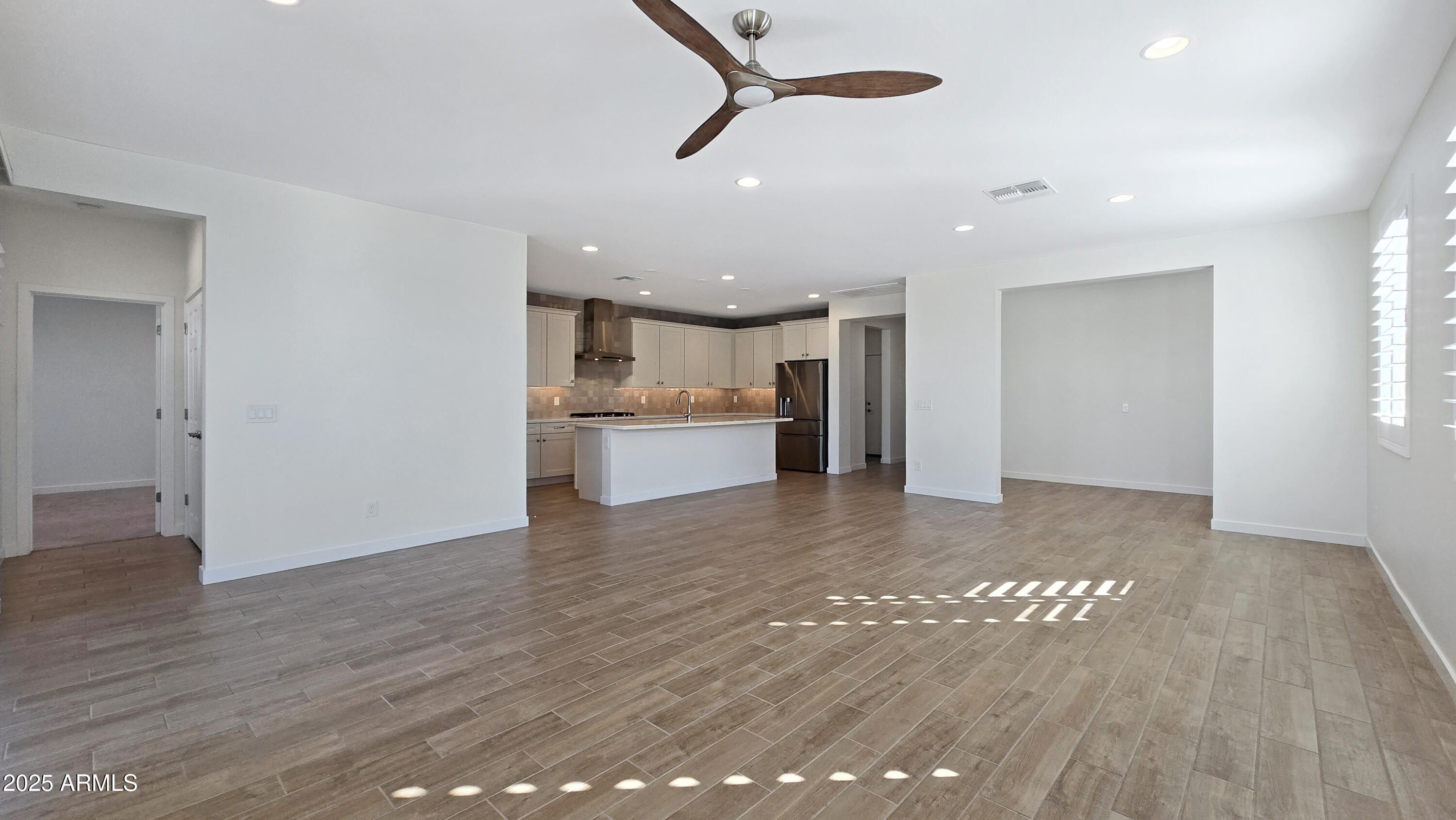 17864 West Thistle Landing Drive Goodyear, AZ 85338 - Photo 6 of 43 a view of a kitchen with a sink and a refrigerator