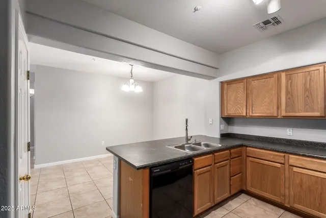 a kitchen with stainless steel appliances granite countertop a refrigerator a stove and a sink