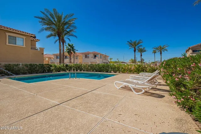 a house with a yard and palm trees