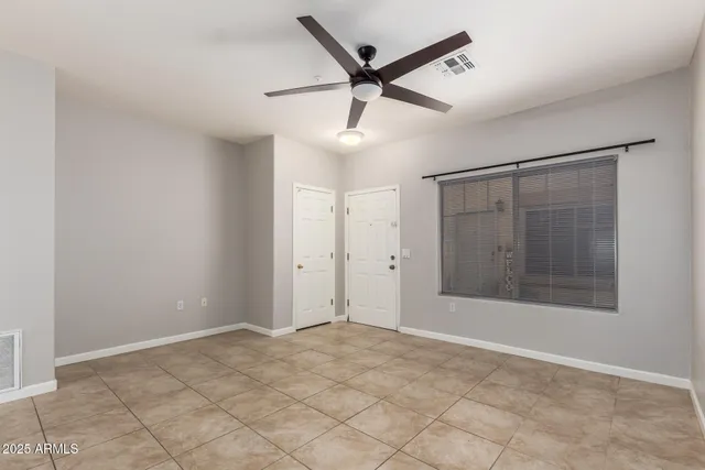 a view of an empty room and a kitchen