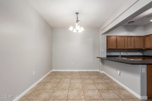 a view of an empty room with a ceiling fan