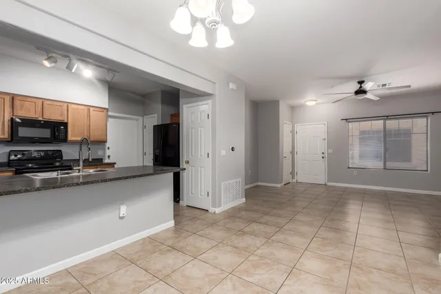 a kitchen with granite countertop a stove and a sink
