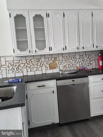 a kitchen with a sink and cabinets