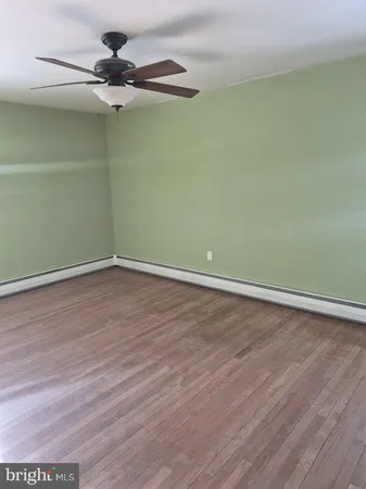 a view of a room with wooden floor