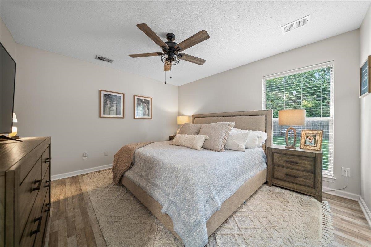 7300 Country Side Road Memphis, TN 38133 - Photo 14 of 22 Bedroom featuring wood-finish flooring, a ceiling fan with light fixture, and a window with blinds