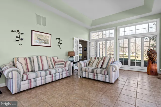 a dining room with furniture wooden floor a rug and a chandelier