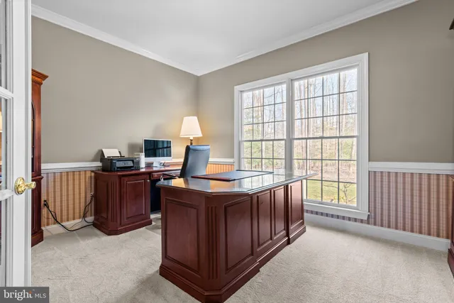 a living room with furniture a flat screen tv and a floor to ceiling window