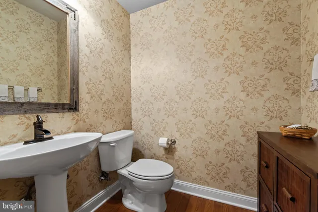 a kitchen with a dining table chairs and refrigerator