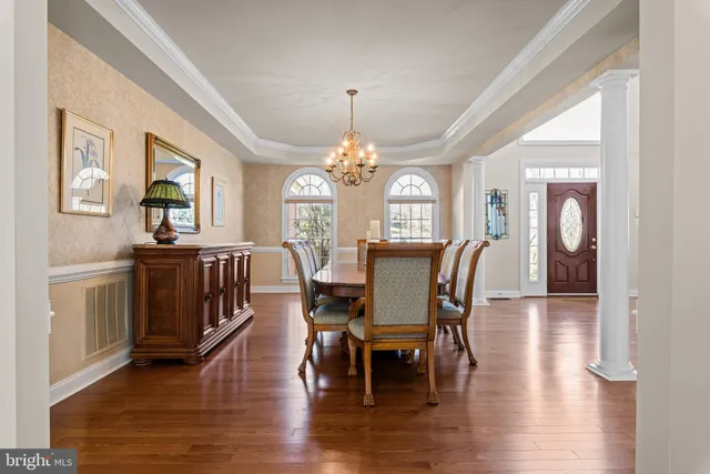 a kitchen with stainless steel appliances granite countertop wooden floors wooden cabinets and a sink