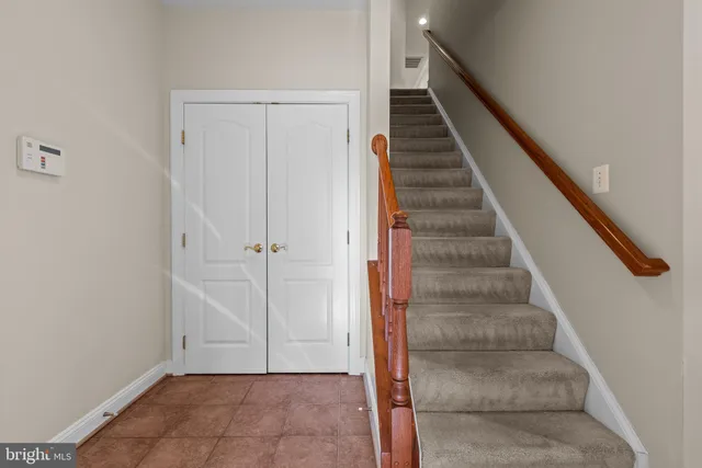 a bedroom with furniture and a large window