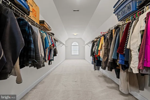 a living room with furniture a flat screen tv and a window