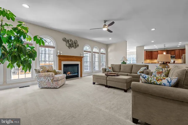 a kitchen with stainless steel appliances granite countertop a stove a sink dishwasher and a refrigerator with wooden cabinets