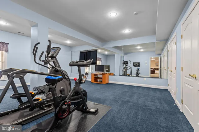 a front view of building with yard and outdoor seating