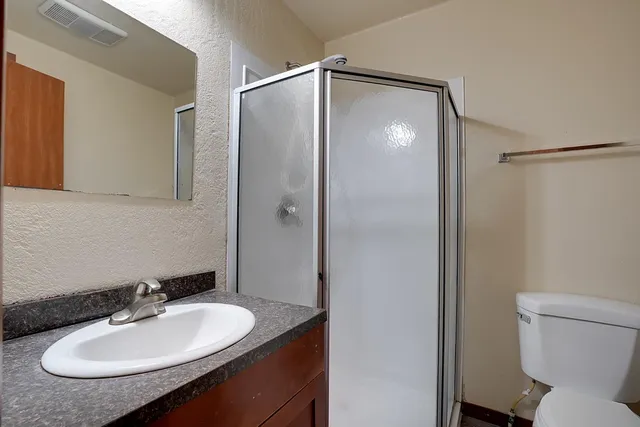 a bathroom with a sink toilet and a mirror