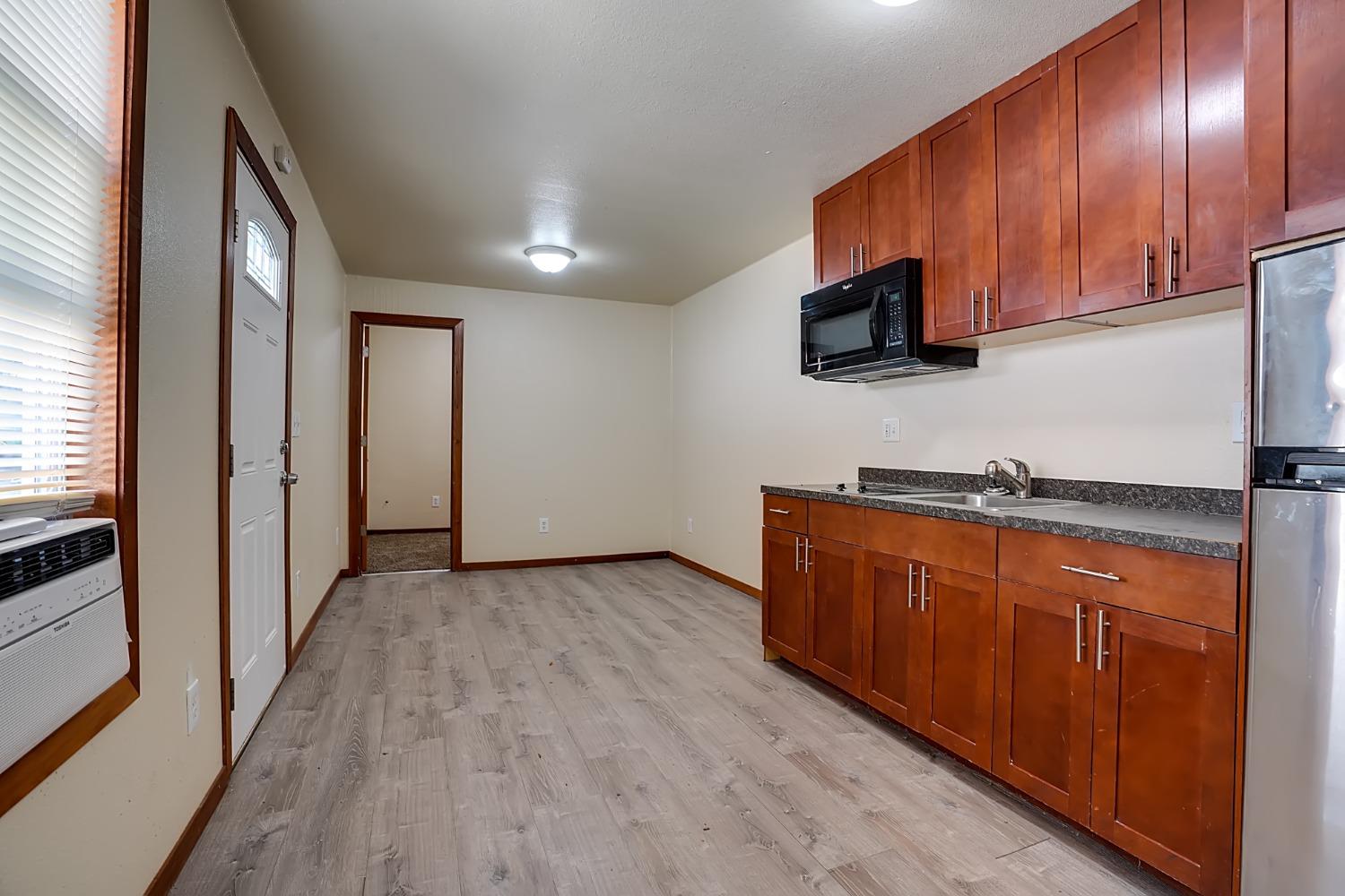 607 Mountain Ranch Road, Unit 2 San Andreas, CA 95249 - Photo 15 of 16 a view of kitchen with stainless steel appliances granite countertop wooden cabinets a refrigerator and sink