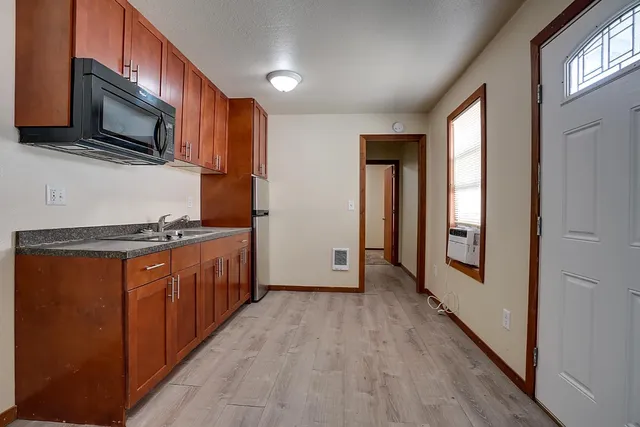 a kitchen with stainless steel appliances granite countertop a refrigerator and a stove top oven