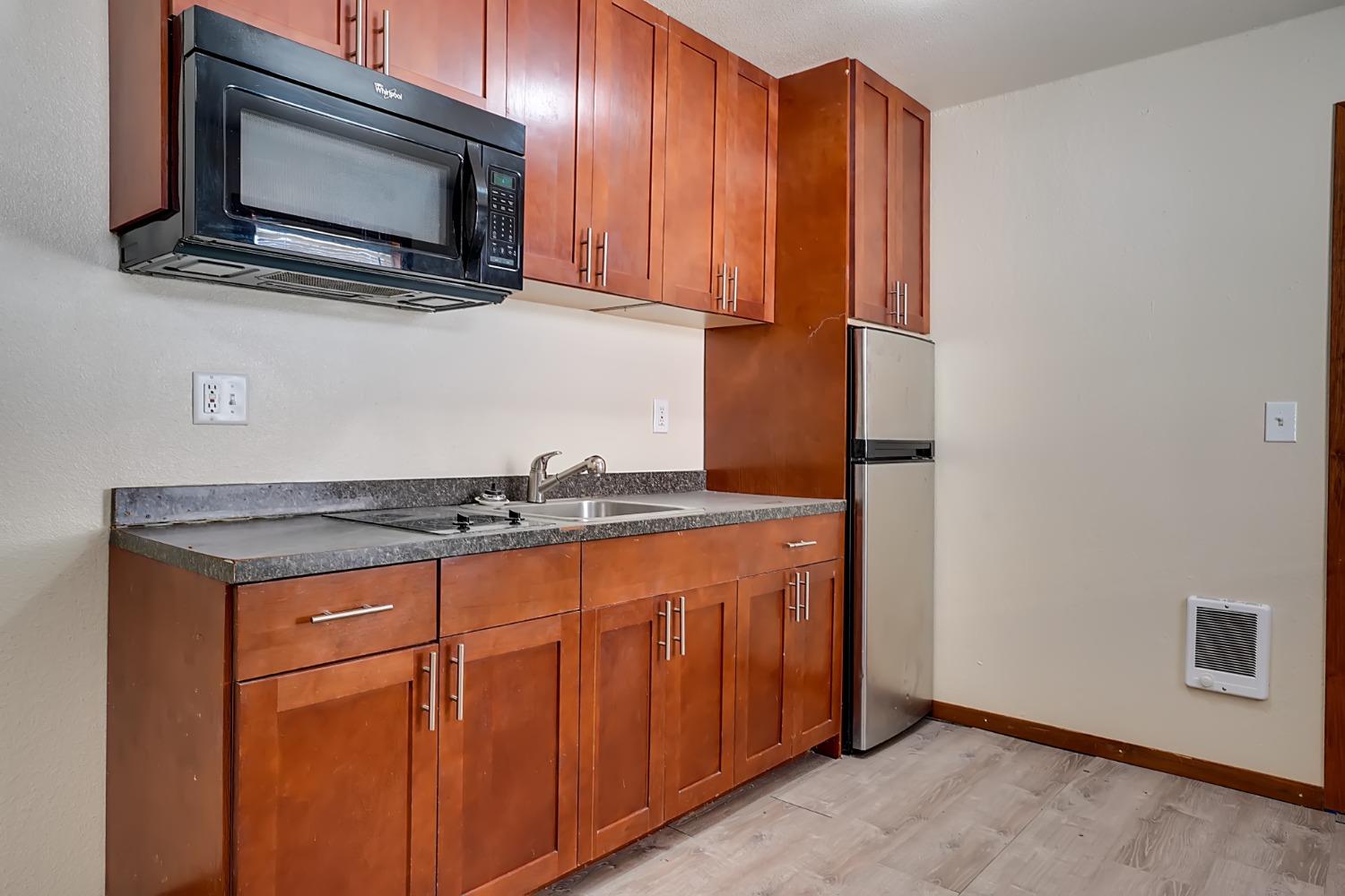 607 Mountain Ranch Road, Unit 2 San Andreas, CA 95249 - Photo 10 of 16 a kitchen with stainless steel appliances granite countertop a stove microwave and sink