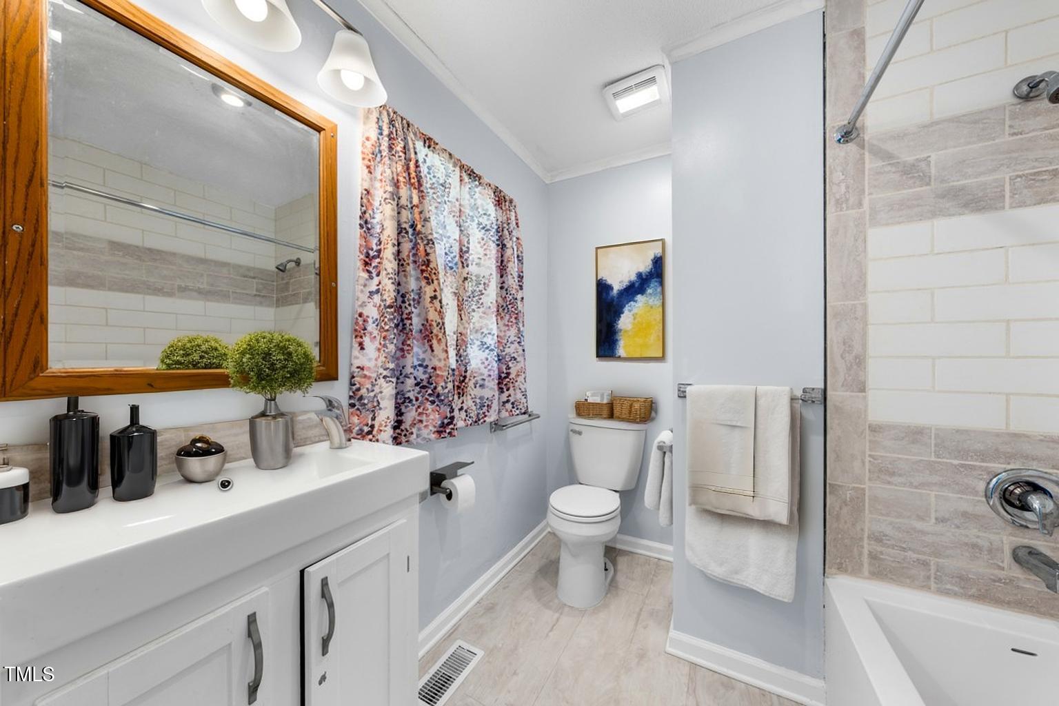 916 Clayton Road Durham, NC 27703 - Photo 9 of 32 a bathroom with a toilet sink and mirror