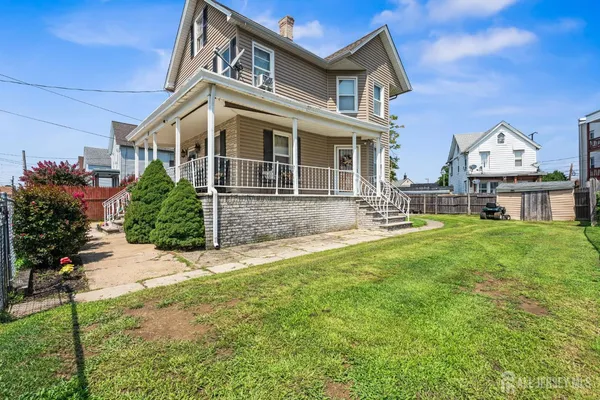 a front view of a house with a yard and porch