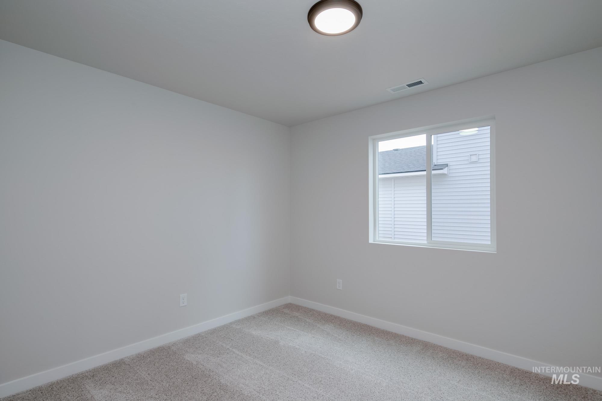 3089 South Maple Rnch Way Nampa, ID 83686 - Photo 3 of 22 Unfurnished room featuring light carpet and baseboards
