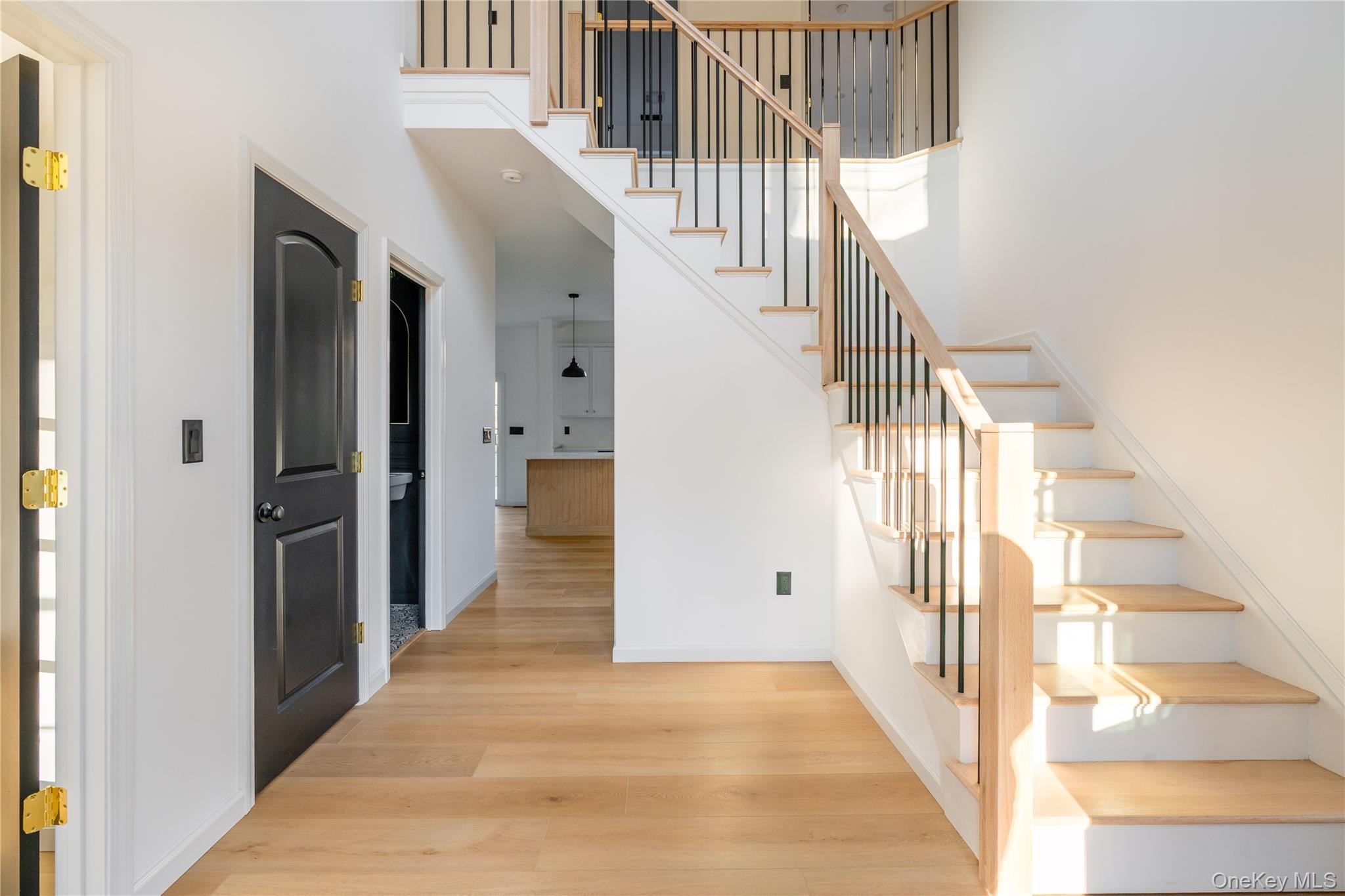 317 Hynes Road Poughquag, NY 12570 - Photo 3 of 12 Staircase featuring wood finished floors and a high ceiling