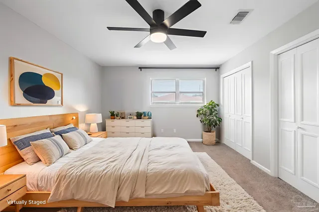 a bedroom with a bed and a potted plant