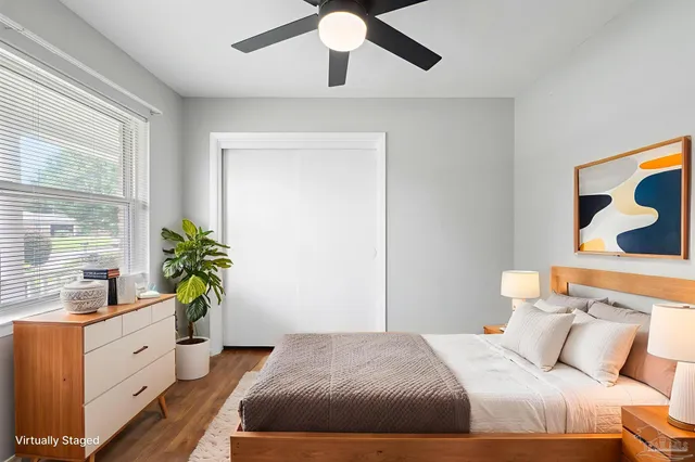 a bedroom with a large bed and a potted plant
