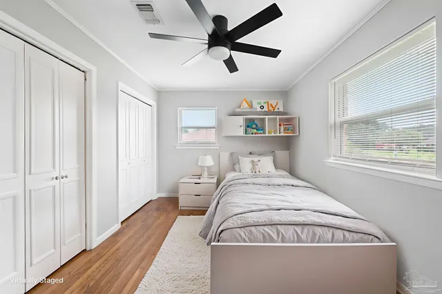 a spacious bedroom with a bed and a window