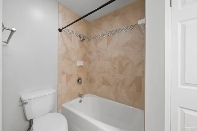 a bathroom with a toilet and a bathtub