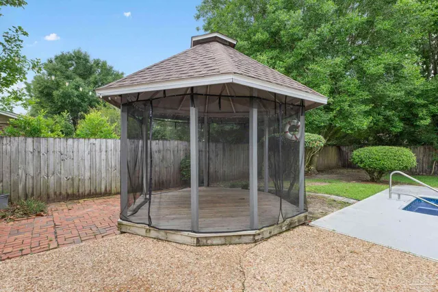 a view of a backyard with a small cabin and a chair