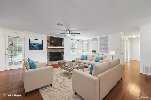 a living room with furniture a fireplace and a flat screen tv