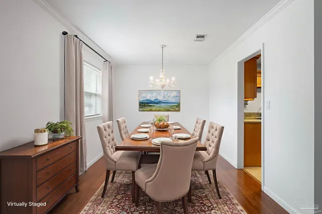 a dining room with furniture a rug and a chandelier