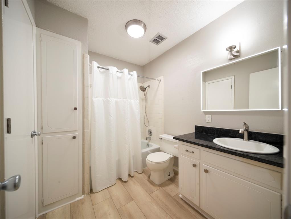 1717 North Locust Street, Unit 5 Denton, TX 76201 - Photo 11 of 11 a bathroom with a granite countertop sink toilet and shower