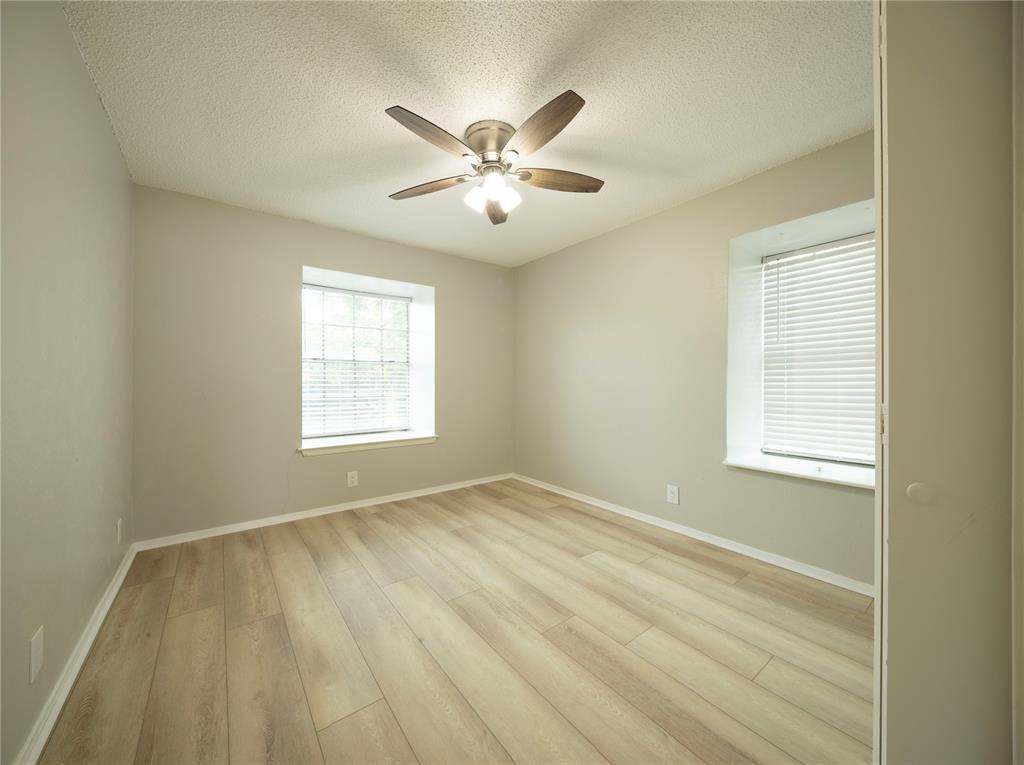 1717 North Locust Street, Unit 5 Denton, TX 76201 - Photo 5 of 11 a view of an empty room with chandelier fan and a window