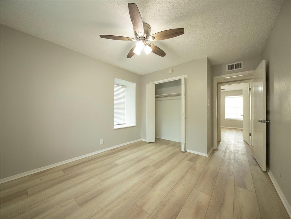 1717 North Locust Street, Unit 5 Denton, TX 76201 - Photo 6 of 11 wooden floor in an empty room with a window