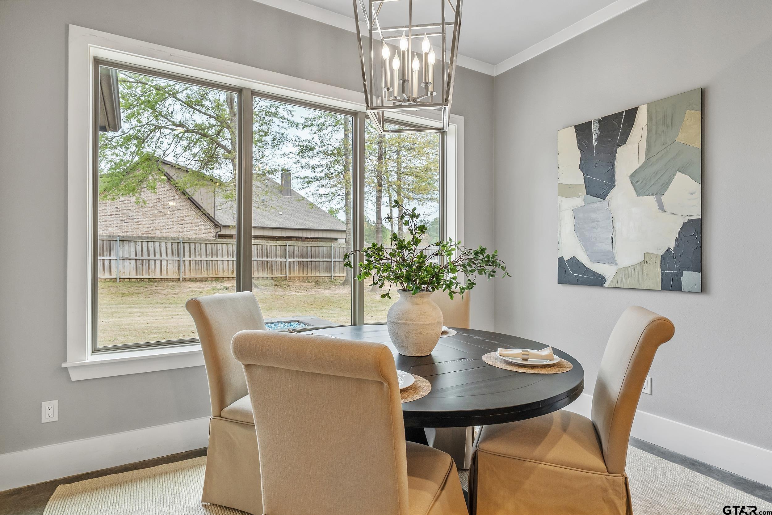 1569 Cooks Crossing Tyler, TX 75703 - Photo 14 of 39 a dining room with furniture a large window and wooden floor