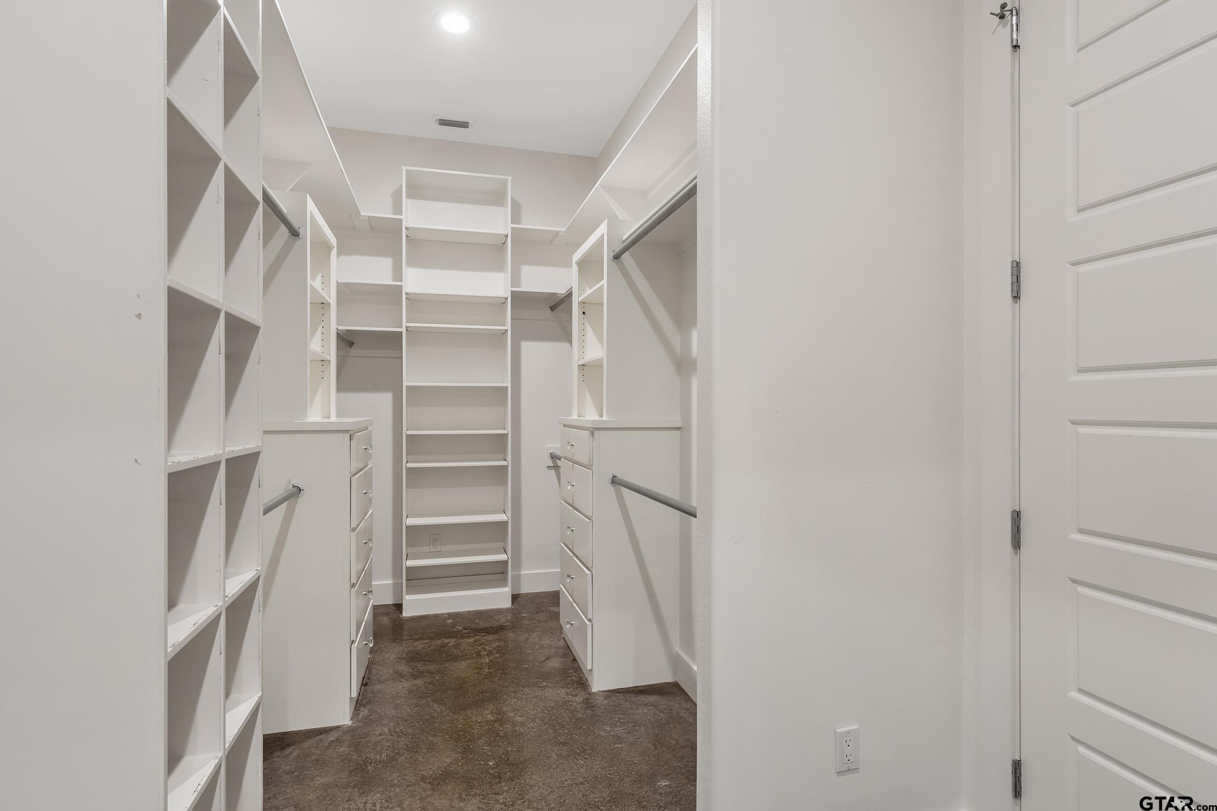 1569 Cooks Crossing Tyler, TX 75703 - Photo 21 of 39 a view of walk in closet with empty racks