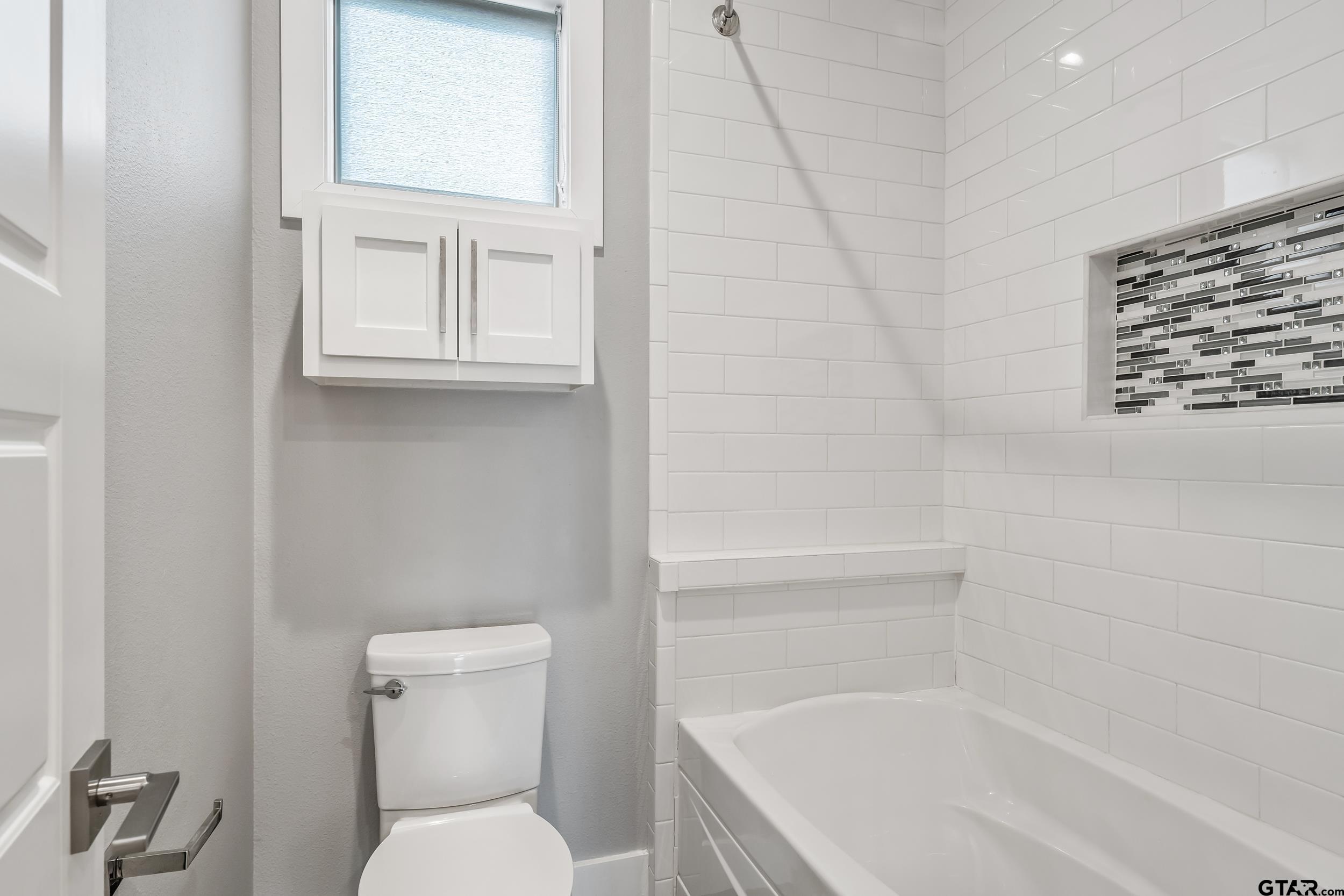 1569 Cooks Crossing Tyler, TX 75703 - Photo 29 of 39 a white toilet sitting next to a bath tub