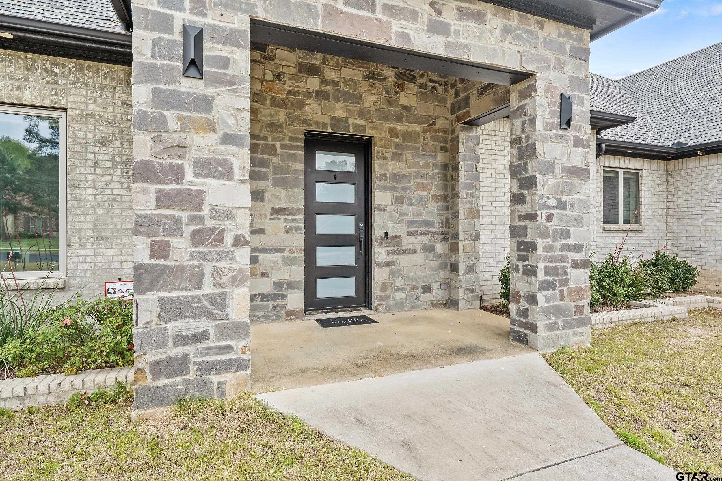 1569 Cooks Crossing Tyler, TX 75703 - Photo 4 of 39 a front view of a house with a yard