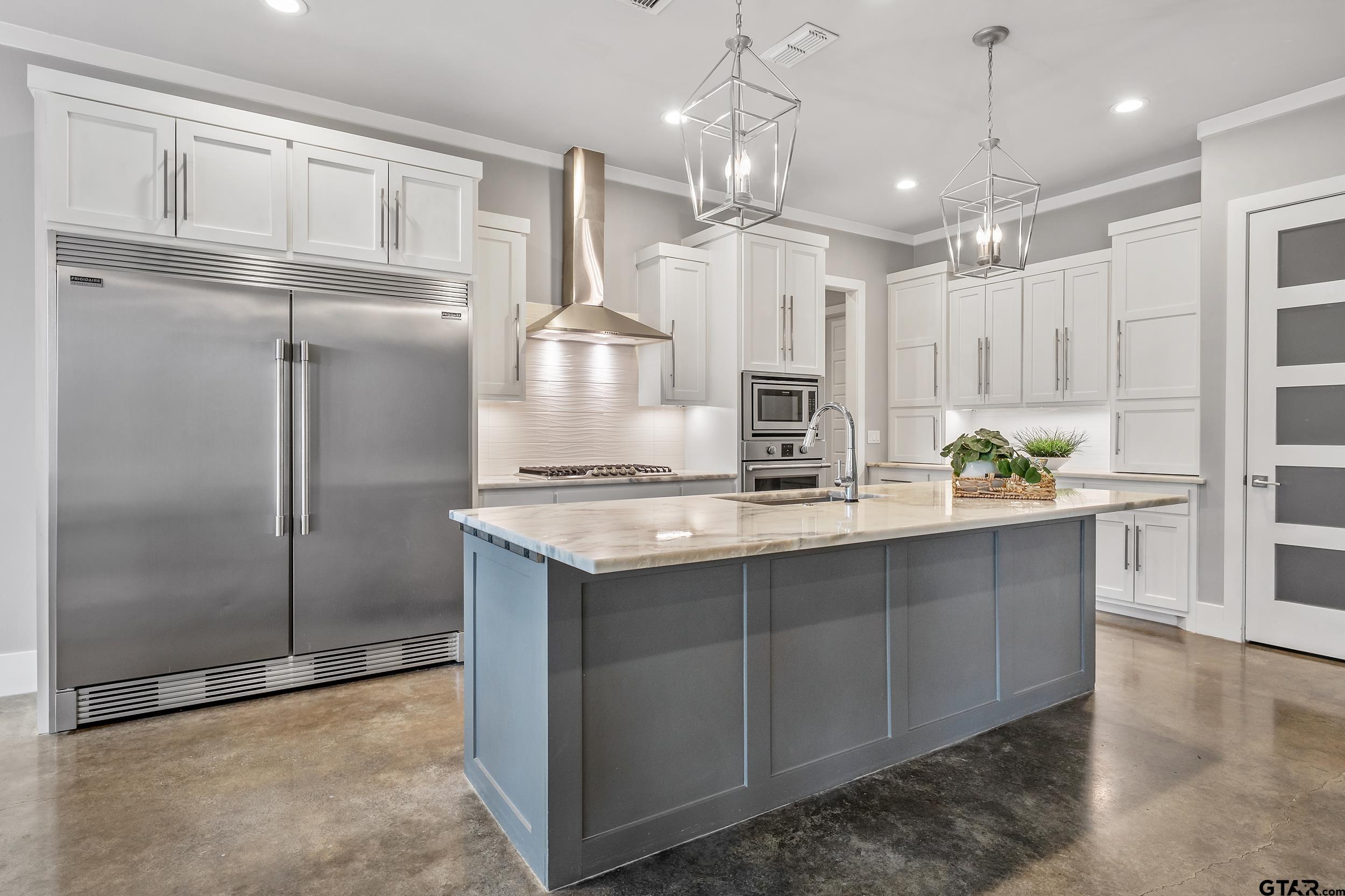 1569 Cooks Crossing Tyler, TX 75703 - Photo 9 of 39 a kitchen with stainless steel appliances a refrigerator a sink cabinets and wooden floor