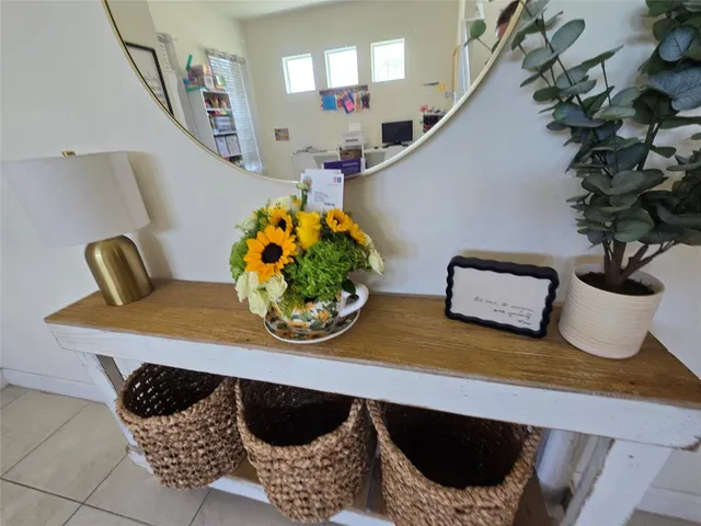 a living room with furniture and potted plant