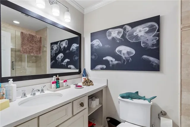 a bathroom with a sink vanity granite and toilet