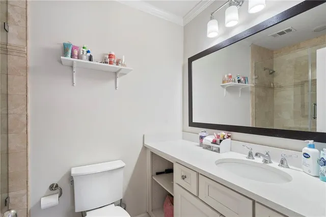 a spacious bedroom with a large bed a flat tv screen and a fireplace