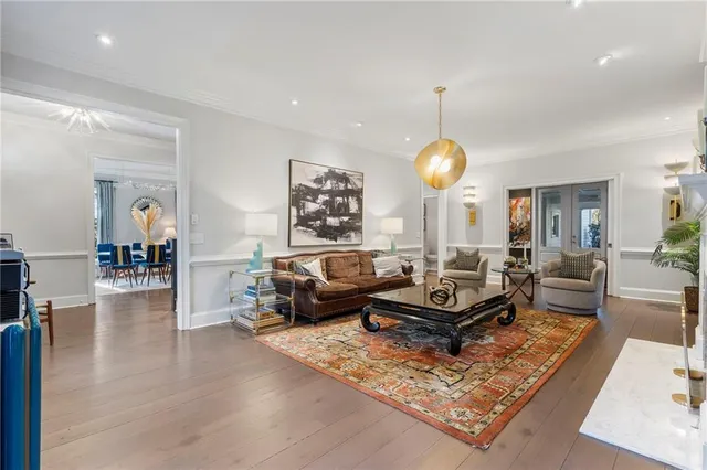 a living room with furniture a fireplace and a chandelier