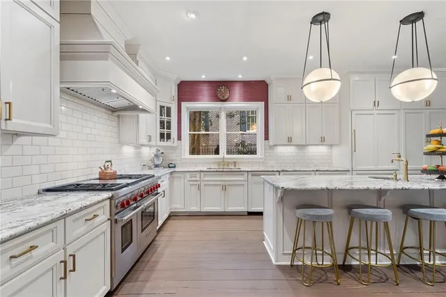 a kitchen with granite countertop stainless steel appliances a sink and cabinets