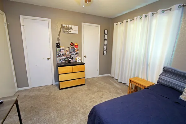 a bedroom with a bed and a window