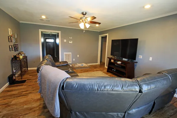 a bed room with a bed mirror and a television