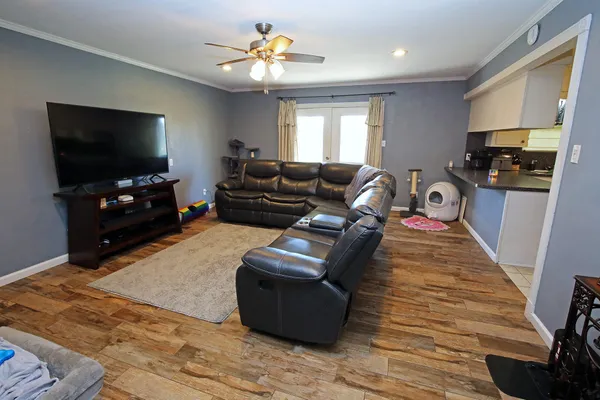a living room with furniture and a flat screen tv